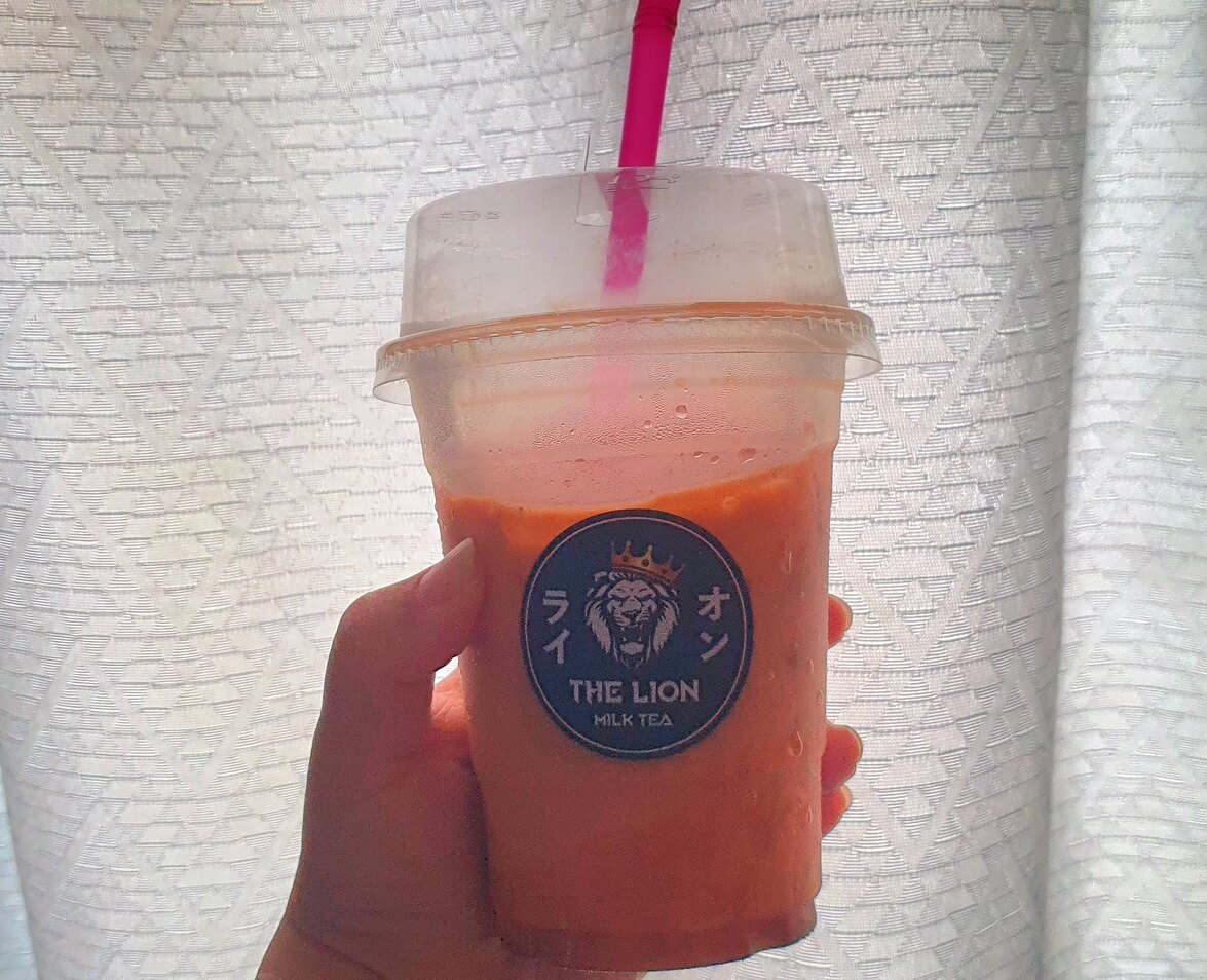 A Person Holding Thai Tea As A Morning Drink 
